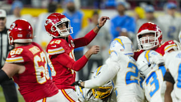 Dec 8, 2024; Kansas City, Missouri, USA; Kansas City Chiefs place kicker Matthew Wright (49) kicks a game winning field goal as time expires against the Los Angeles Chargers at GEHA Field at Arrowhead Stadium. Mandatory Credit: Jay Biggerstaff-Imagn Images