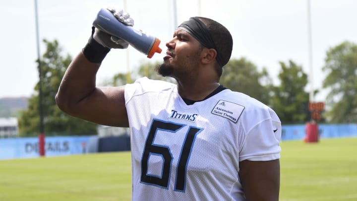 Jul 29, 2023; Nashville, TN, USA; Tennessee Titans offensive tackle John Ojukwu (61) drinks water after training camp. Mandatory Credit: Christopher Hanewinckel-USA TODAY Sports