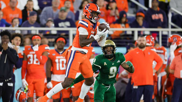 Dec 21, 2023; Boca Raton, FL, USA;  Syracuse Orange wide receiver Damien Alford (5) catches a pass defended by South Florida Bulls defensive back Aamaris Brown (9) in the second quarter during the RoofClaim.com Boca Raton Bowl at FAU Stadium. Mandatory Credit: Nathan Ray Seebeck-USA TODAY Sports