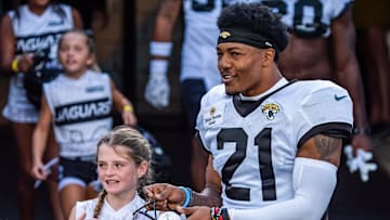 Jacksonville Jaguars cornerback Christian Braswell (21) gets his helmet from a young lady during Helmet Walk before an NFL scrimmage at EverBank Stadium Friday August 1, 2025, in Jacksonville, Fla. [Doug Engle/Florida Times-Union]