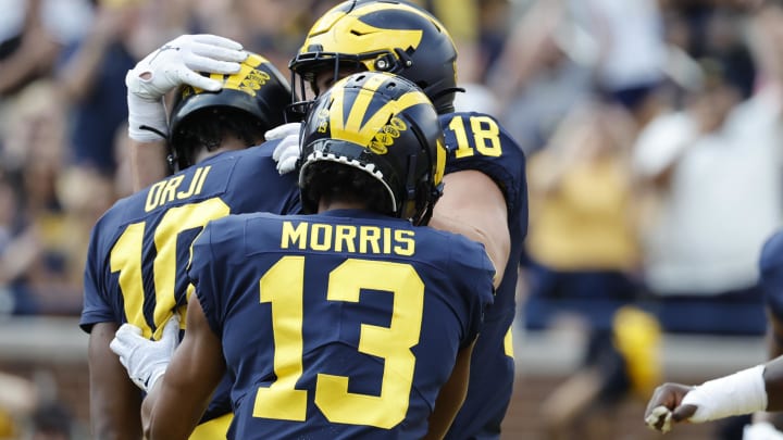 Sep 17, 2022; Ann Arbor, Michigan, USA;  Michigan Wolverines quarterback Alex Orji (10) receives congratulations from teammates after he rushes for a touchdown in the second half against the Connecticut Huskies at Michigan Stadium. Mandatory Credit: Rick Osentoski-USA TODAY Sports