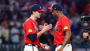 Sep 27, 2024; Atlanta, Georgia, USA; Atlanta Braves starting pitcher Max Fried (54) and relief pitcher Raisel Iglesias (26) celebrate after a victory over the Kansas City Royals at Truist Park. Mandatory Credit: Brett Davis-Imagn Images