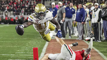 Nov 29, 2024; Athens, Georgia, USA; Georgia Tech Yellow Jackets running back Jamal Haynes (11) scores a touchdown past Georgia Bulldogs defensive back Dan Jackson (17) during the first half at Sanford Stadium. Mandatory Credit: Dale Zanine-Imagn Images