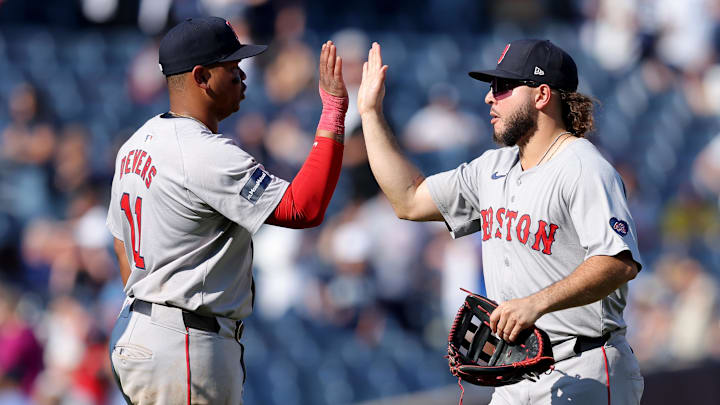 Sep 14, 2024; Bronx, New York, USA; Boston Red Sox third baseman Rafael Devers (11) high fives right fielder Wilyer Abreu (52) after defeating the New York Yankees at Yankee Stadium. Mandatory Credit: Brad Penner-Imagn Images