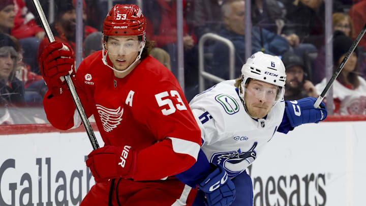 Dec 1, 2024; Detroit, Michigan, USA;  Detroit Red Wings defenseman Moritz Seider (53) and Vancouver Canucks right wing Brock Boeser (6) fight for position in the first period at Little Caesars Arena. Mandatory Credit: Rick Osentoski-Imagn Images