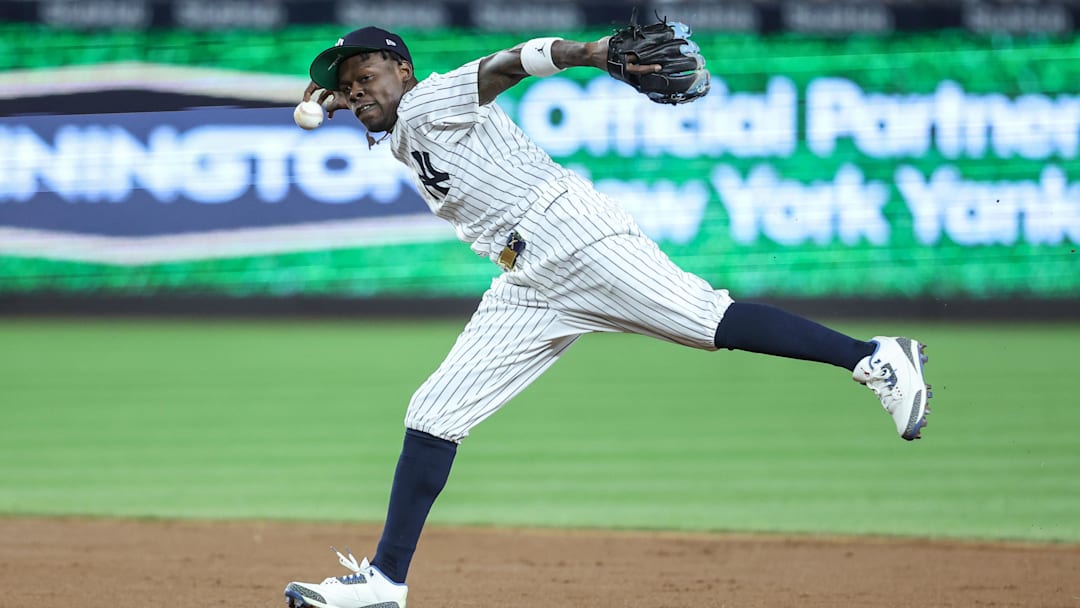 Apr 15, 2025; Bronx, New York, USA;  New York Yankees second baseman Jazz Chisholm Jr. (13) tries to make a running throw to first base in the fifth inning against the Kansas City Royals at Yankee Stadium. All players wore #42 for Jackie Robinson Day.