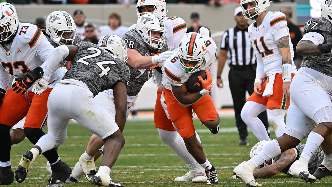 Nov 22, 2025; Blacksburg, Virginia, USA;  Miami (FL) Hurricanes running back Charmar Brown (6) runs the ball as Virginia Tech Hokies linebacker Jaden Keller (24) defends at Lane Stadium. Mandatory Credit: Brian Bishop-Imagn Images