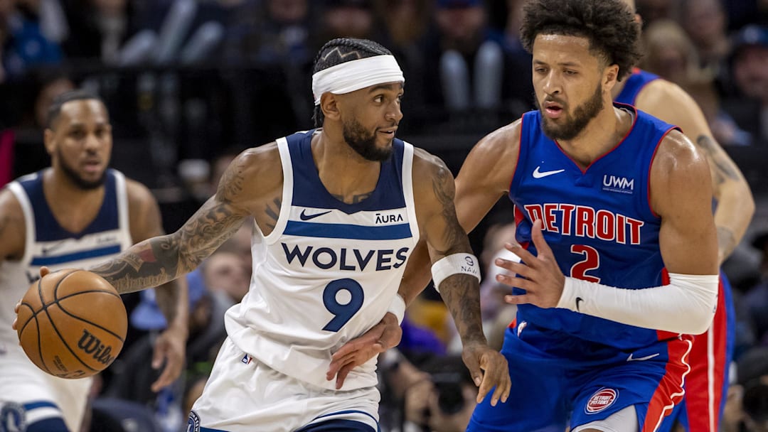 Minnesota Timberwolves guard Nickeil Alexander-Walker (9) dribbles the ball as Detroit Pistons guard Cade Cunningham (2) plays defense in the second half at Target Center. 