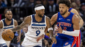 Minnesota Timberwolves guard Nickeil Alexander-Walker (9) dribbles the ball as Detroit Pistons guard Cade Cunningham (2) plays defense in the second half at Target Center. 