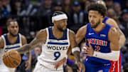 Mar 27, 2024; Minneapolis, Minnesota, USA; Minnesota Timberwolves guard Nickeil Alexander-Walker (9) dribbles the ball as Detroit Pistons guard Cade Cunningham (2) plays defense in the second half at Target Center. Mandatory Credit: Jesse Johnson-Imagn Images