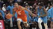 Feb 19, 2025; Tallahassee, Florida, USA; Miami Hurricanes guard Matthew Cleveland (0) drives the ball to the net as Florida State Seminoles forward AJ Swinton (19) defends during the second half at Donald L. Tucker Center. Mandatory Credit: Melina Myers-Imagn Images
