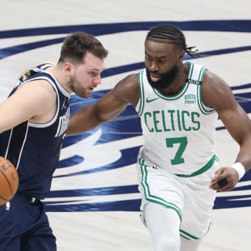 Jun 14, 2024; Dallas, Texas, USA; Dallas Mavericks guard Luka Doncic (77) dribbles against Boston Celtics guard Jaylen Brown (7) during the first half of game four of the 2024 NBA Finals at American Airlines Center. Mandatory Credit: Kevin Jairaj-USA TODAY Sports