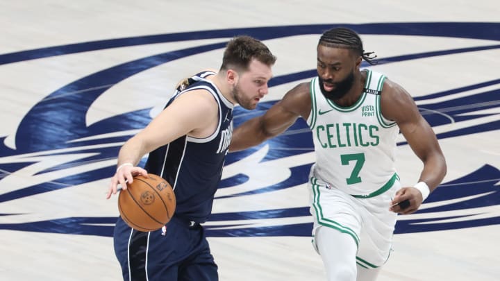 Jun 14, 2024; Dallas, Texas, USA; Dallas Mavericks guard Luka Doncic (77) dribbles against Boston Celtics guard Jaylen Brown (7) during the first half of game four of the 2024 NBA Finals at American Airlines Center. Mandatory Credit: Kevin Jairaj-USA TODAY Sports