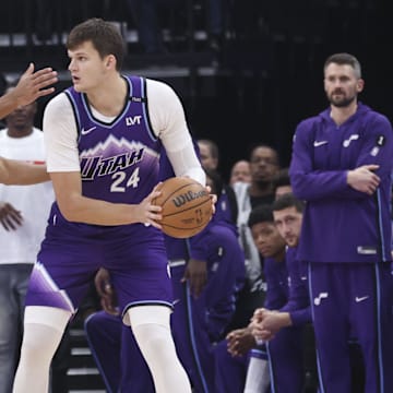 Oct 27, 2025; Salt Lake City, Utah, USA; Utah Jazz center Walker Kessler (24) looks to pass against Phoenix Suns forward Oso Ighodaro (11) during the first quarter at Delta Center. Mandatory Credit: Rob Gray-Imagn Images