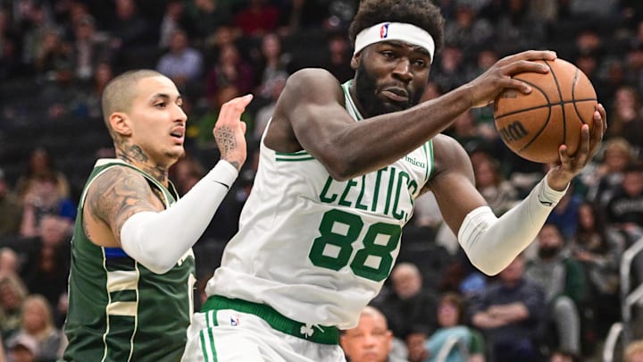 Dec 11, 2025; Milwaukee, Wisconsin, USA; Boston Celtics center Neemias Queta (88) grabs a rebound against Milwaukee Bucks forward Kyle Kuzma (18) in the fourth quarter at Fiserv Forum.