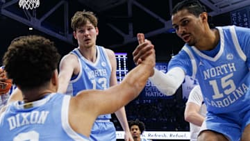 Dec 2, 2025; Lexington, Kentucky, USA; North Carolina Tar Heels guard Derek Dixon (3) is helped to his feet by center Henri Veesaar (13) and forward Jarin Stevenson (15) during the first half against the Kentucky Wildcats at Rupp Arena at Central Bank Center. Mandatory Credit: Jordan Prather-Imagn Images