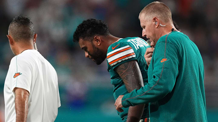 Sep 12, 2024; Miami Gardens, Florida, USA; Miami Dolphins quarterback Tua Tagovailoa (1) walks off the field with training staff after an apparent injury during the second half against the Buffalo Bills at Hard Rock Stadium. Mandatory Credit: Jasen Vinlove-Imagn Images