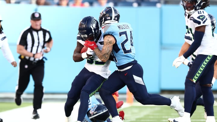 Aug 17, 2024; Nashville, Tennessee, USA; Seattle Seahawks wide receiver Dee Williams (33) is pushed out of bounds by Tennessee Titans cornerback Elijah Molden (24) in the first quarter of the game at Nissan Stadium. Mandatory Credit: Casey Gower-USA TODAY Sports