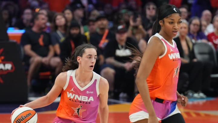 Jul 20, 2024; Phoenix, AZ, USA; Team WNBA guard Caitlin Clark (22) dribbles alongside Team WNBA forward Angel Reese (5) against USA Women's National Team during the WNBA All Star Game at Footprint Center. Mandatory Credit: Joe Camporeale-USA TODAY Sports