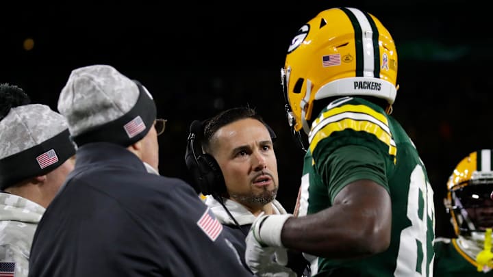 Green Bay Packers head coach Matt LaFleur checks on wide receiver Romeo Doubs (87) after he was injured on a pass interference by San Francisco 49ers cornerback Renardo Green (0) in the endzone in the third quarter during their football game Sunday, November 24, 2024, at Lambeau Field in Green Bay, Wisconsin. Doubs had to leave the game.