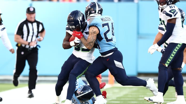 Aug 17, 2024; Nashville, Tennessee, USA; Seattle Seahawks wide receiver Dee Williams (33) is pushed out of bounds by Tennessee Titans cornerback Elijah Molden (24) in the first quarter of the game at Nissan Stadium.