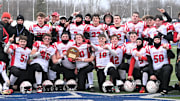 The Morrisville-Eaton Mavericks pose with their championship plaque after beating the Eldred Yellowjackets 40-12 in New York's state regional eight-player football championship game at Cicero-North Syracuse High School's Michael J. Bragman Athletic Complex Sunday, Nov. 30, 2025, in Cicero, New York.