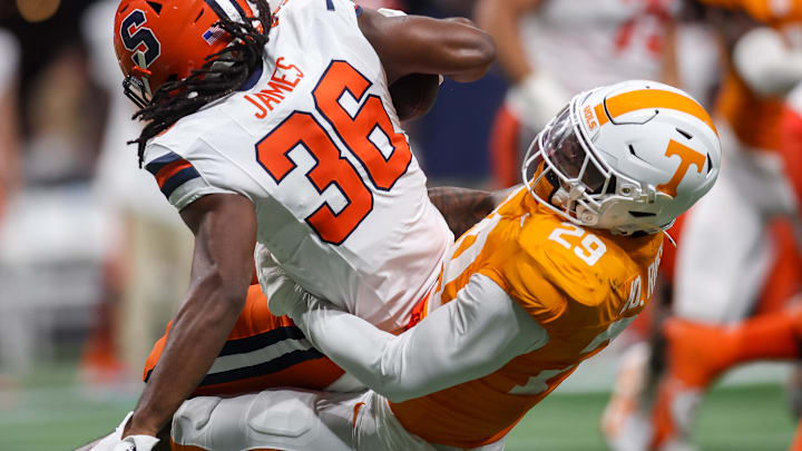 Aug 30, 2025; Atlanta, Georgia, USA; Syracuse Orange running back Malachi James (36) is tackled by Tennessee Volunteers defensive lineman Jordan Ross (29) in the third quarter at Mercedes-Benz Stadium. 