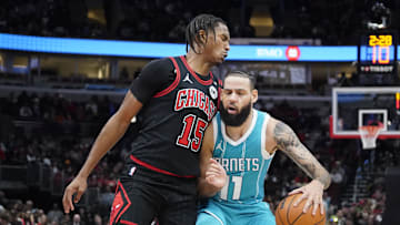 Jan 17, 2025; Chicago, Illinois, USA; Chicago Bulls forward Julian Phillips (15) defends Charlotte Hornets forward Cody Martin (11) during the second half at United Center. Mandatory Credit: David Banks-Imagn Images