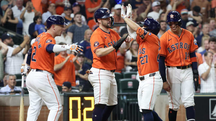 Jul 12, 2024; Houston, Texas, USA;  Houston Astros left fielder Chas McCormick (20) and teammates celebrate second baseman Jose Altuve's (27) three-run home run in the seventh inning at Minute Maid Park. Mandatory Credit: Thomas Shea-USA TODAY Sports