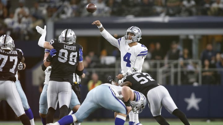 Nov 25, 2021; Arlington, Texas, USA; Dallas Cowboys quarterback Dak Prescott (4) throws the ball while pressured by Las Vegas Raiders linebacker Javin White (53) in the second quarter at AT&T Stadium. Mandatory Credit: Tim Heitman-USA TODAY Sports