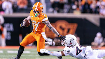 Oct 18, 2025; Stillwater, Oklahoma, USA; Cincinnati Bearcats linebacker Montay Weedon (44) dives for  Oklahoma State Cowboys wide receiver Gavin Freeman (17) during the first half at Boone Pickens Stadium. Mandatory Credit: William Purnell-Imagn Images