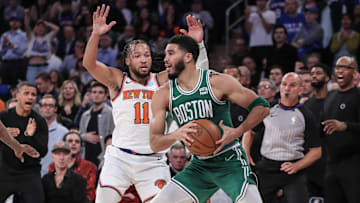 Boston Celtics forward Jayson Tatum is guarded by New York Knicks guard Jalen Brunson while trying to make a pass.