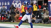 Nov 24, 2024; East Rutherford, New Jersey, USA; New York Giants running back Devin Singletary (26) celebrates after his rushing touchdown during the second half against the Tampa Bay Buccaneers at MetLife Stadium.  