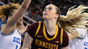 Feb 2, 2025; Los Angeles, California, USA; Minnesota Golden Gophers forward Mallory Heyer (24) drives to the basket past UCLA Bruins guard Kiki Rice (1) during the first quarter at Pauley Pavilion presented by Wescom. Mandatory Credit: Robert Hanashiro-Imagn Images