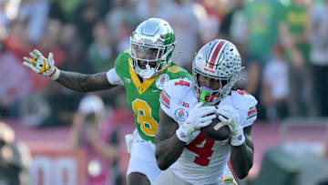 Jan 1, 2025; Pasadena, CA, USA; Ohio State Buckeyes wide receiver Jeremiah Smith (4) makes a catch against Oregon Ducks defensive back Dontae Manning (8) in the first quarter in the 2025 Rose Bowl college football quarterfinal game at Rose Bowl Stadium. Mandatory Credit: Jayne Kamin-Oncea-Imagn Images