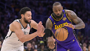 Jan 17, 2025; Los Angeles, California, USA;  Los Angeles Lakers forward LeBron James (23) is defended by Brooklyn Nets guard Ben Simmons (10) as he takes the ball down court in the second half at Crypto.com Arena. Mandatory Credit: Jayne Kamin-Oncea-Imagn Images