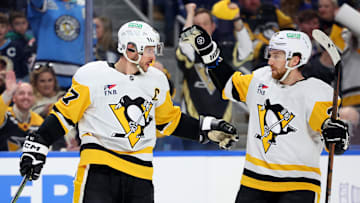 Mar 27, 2025; Buffalo, New York, USA;  Pittsburgh Penguins center Sidney Crosby (87) celebrates his goal with defenseman Matt Grzelcyk (24) during the first period against the Buffalo Sabres at KeyBank Center. Mandatory Credit: Timothy T. Ludwig-Imagn Images