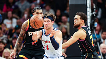Jan 25, 2025; Phoenix, Arizona, USA; Washington Wizards forward Corey Kispert (24) passes the ball while Phoenix Suns center Nick Richards (4) and guard Tyus Jones (21) watch during the second quarter at Footprint Center. Mandatory Credit: Aryanna Frank-Imagn Images