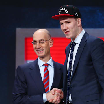 Jun 23, 2016; New York, NY, USA; Jakob Poeltl (Utah) greets NBA commissioner Adam Silver after being selected as the number nine overall pick to the Toronto Raptors in the first round of the 2016 NBA Draft at Barclays Center. Mandatory Credit: Jerry Lai-Imagn Images