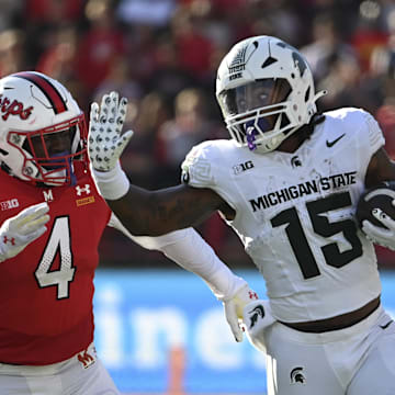 Sep 7, 2024; College Park, Maryland, USA; Michigan State Spartans running back Kay'Ron Lynch-Adams (15) rushes as Maryland Terrapins linebacker Ruben Hyppolite II (4) chases during the second half  at SECU Stadium. Mandatory Credit: Tommy Gilligan-Imagn Images