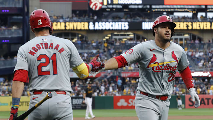 Jul 23, 2024; Pittsburgh, Pennsylvania, USA;  St. Louis Cardinals right fielder Lars Nootbaar (21) congratulates third baseman Nolan Arenado (28) crossing home plate on a solo home run against the Pittsburgh Pirates during the fifth inning at PNC Park. Mandatory Credit: Charles LeClaire-Imagn Images