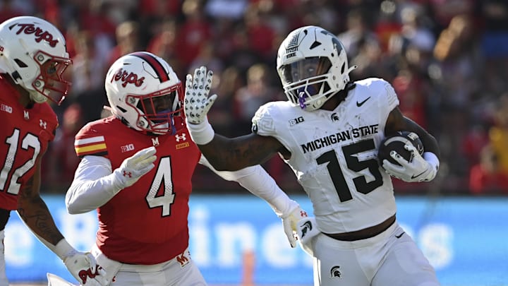 Sep 7, 2024; College Park, Maryland, USA; Michigan State Spartans running back Kay'Ron Lynch-Adams (15) rushes as Maryland Terrapins linebacker Ruben Hyppolite II (4) chases during the second half  at SECU Stadium. Mandatory Credit: Tommy Gilligan-Imagn Images