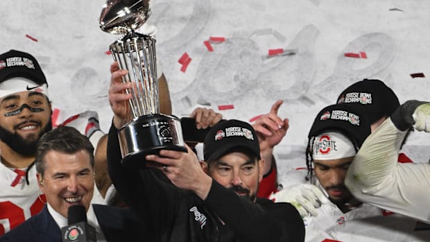Ohio State Buckeyes head coach Ryan Day holds up the Rose Bowl championship trophy after defeating the Oregon Ducks at Rose B