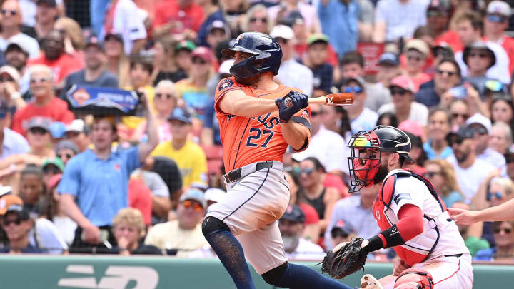 Aug 11, 2024; Boston, Massachusetts, USA; Houston Astros designated hitter Jose Altuve (27) hits a single against the Boston Red Sox during the third inning at Fenway Park. 