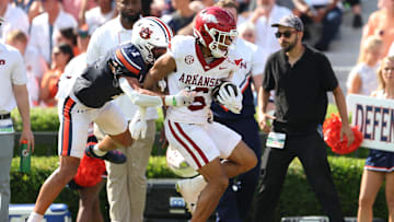 Sep 21, 2024; Auburn, Alabama, USA;  Auburn Tigers safety Jerrin Thompson (1) tackles Arkansas Razorbacks wide receiver Isaiah Sategna (6) during the first quarter at Jordan-Hare Stadium. Mandatory Credit: John Reed-Imagn Images
