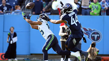 Dec 24, 2023; Nashville, Tennessee, USA; Seattle Seahawks wide receiver Tyler Lockett (16) misses a pass as he is defended by Tennessee Titans safety Mike Brown (44) during the first half at Nissan Stadium. Mandatory Credit: Christopher Hanewinckel-Imagn Images