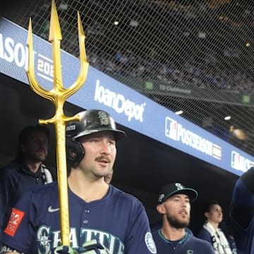 Oct 20, 2025; Toronto, Ontario, CAN; Seattle Mariners catcher Cal Raleigh (29) celebrates in the dugout after scoring against the Toronto Blue Jays in the fifth inning during game seven of the ALCS round for the 2025 MLB playoffs at Rogers Centre. Mandatory Credit: John E. Sokolowski-Imagn Images