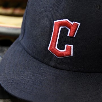 Aug 10, 2022; Detroit, Michigan, USA;  The gloves and hats of Cleveland Guardians players on the dugout steps between innings against the Detroit Tigers at Comerica Park.