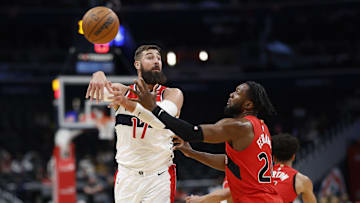 Oct 11, 2024; Washington, District of Columbia, USA; Washington Wizards center Jonas Valanciunas (17) passes the ball as Toronto Raptors guard Jamal Shead (23) defends in the second quarter at Capital One Arena. Mandatory Credit: Geoff Burke-Imagn Images