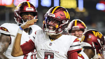 Washington Commanders quarterback Jayden Daniels reacts after scoring a touchdown against the Cincinnati Bengals.